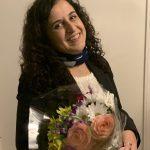 Amal Eqeiq with bouquet of flowers