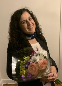 Amal Eqeiq with bouquet of flowers